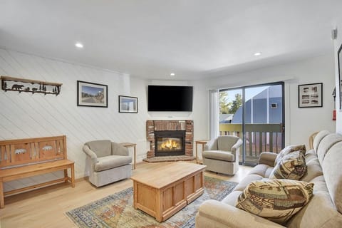 Comfortable Living Room with an electric fireplace and deck