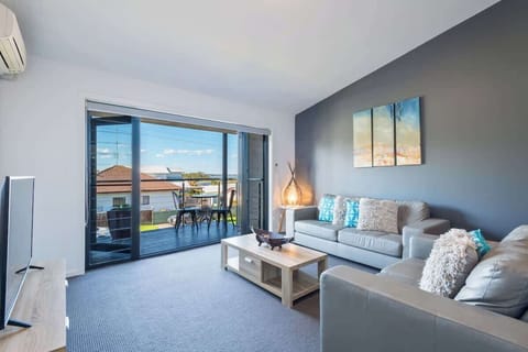 Lounge room and north-facing balcony in Greenfields Jervis Bay holiday rentals.