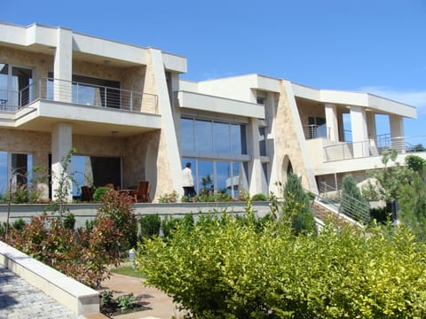House  facade with travertin and limestone ,   facing the sea 