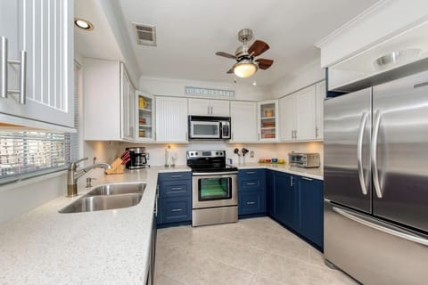 Kitchen including microwave, dishwasher, electric range, coffee maker, etc.