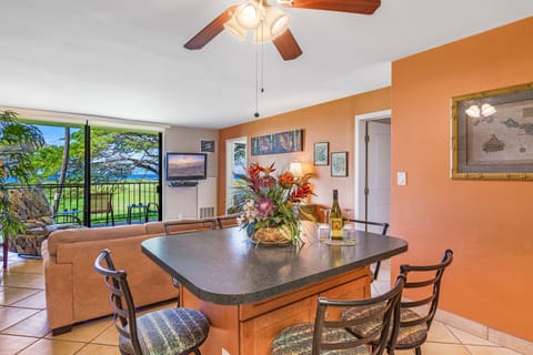 Open concept sitting at dining table overlooking living room and view