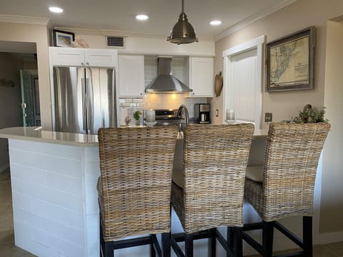 Kitchen opens to living area with gorgeous  views. Counter seating.