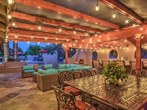Huge Outdoor Covered Patio with hanging lights and lot's of patio furniture.
