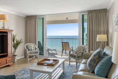 Spacious coastal living room/den with a beautiful gulf view and balcony