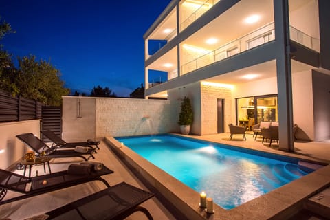 Seafront Villa Petra in the evening with beautiful lights & heated Pool