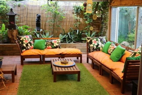 Large undercover entertaining area with bali them sofa, outdoor setting with bar