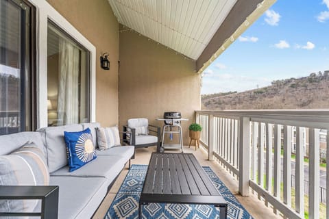 Private balcony with comfortable seating and Ozark views