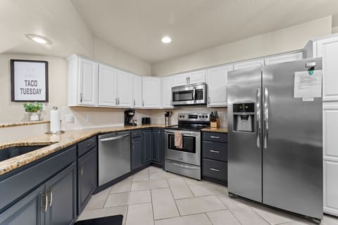 Fully stocked kitchen with stainless appliances and granite counters