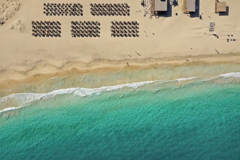On the beach, white sand, sun loungers, beach umbrellas