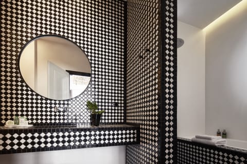 Bathtub, designer toiletries, hair dryer, bathrobes