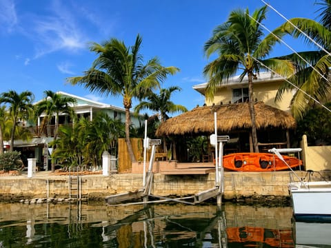 Private waterfront tiki hut overlooking the canal, with covered outdoor dining, 