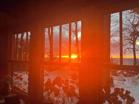 Sunsets illuminate throughout living room windows.
