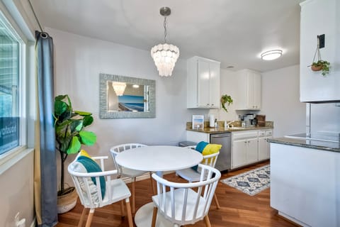 This dining table seats four and is located next to an attached galley kitchen.