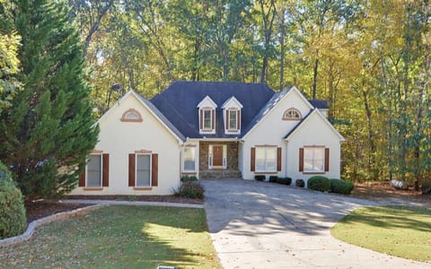 Located in a quiet neighborhood with a big yard and surrounded by lush woodland.