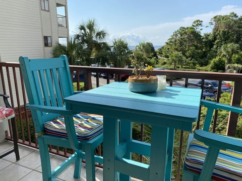 Outdoor pub table with two chairs and two stools