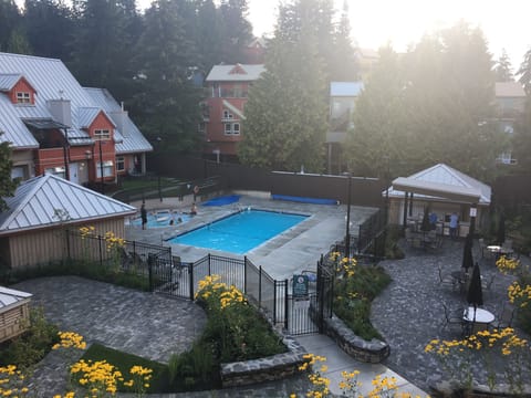 view from our deck-heated (83deg) pool, hot tub, bar bq, patio and garden 