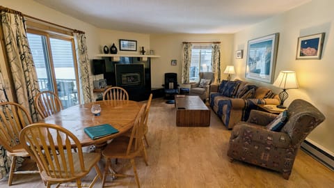 Living room with sofa bed, gas fireplace, and patio w/ propane BBQ grill
