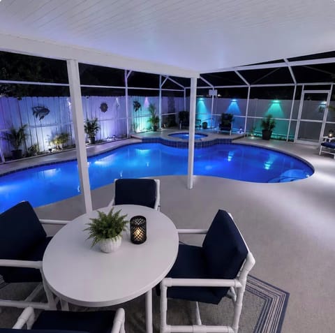 Evening paradise awaits on the screened patio with a glowing private pool 