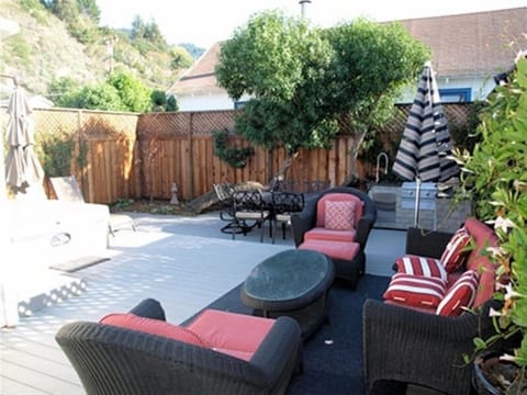 Backyard w/ sitting area, gas BBQ and outdoor kitchen, dining table and hot tub