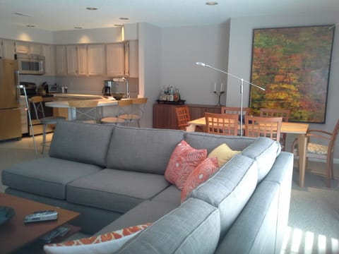 Open living and dining area just off the screened porch. 
