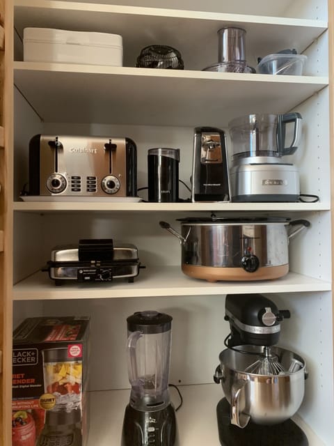 Well stocked kitchen with mixer, blender, crock pot, waffle iron, coffee grinder