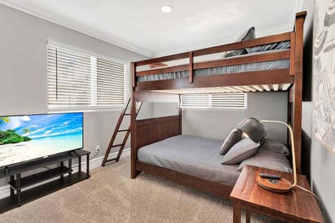 Family-Friendly Bunk Room: Host the whole group with ease in this cozy kids` room, featuring a solid wood bunk bed set, plush mattresses, and a smart TV setup.