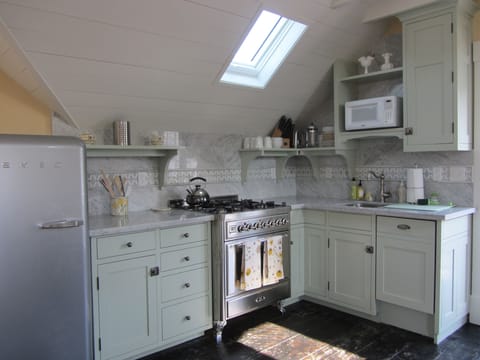 ILVE dual fuel range, SMEG fridge. Marble counter, Bosch dishwasher, SMEG fridge