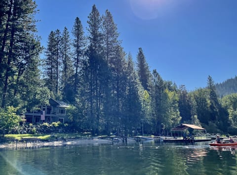 Our home, sandy beach and dock on secluded bay