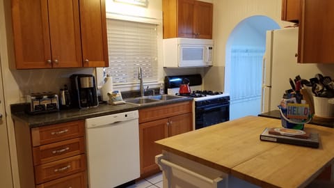 Kitchen w/archway and one step down into dining room
