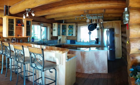 Large Kitchen with granite counter tops and bar with stools