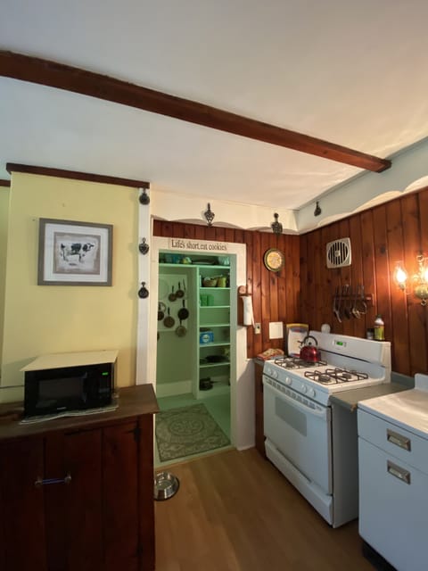 Kitchen view towards pantry and bathroom.
