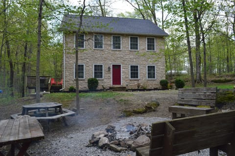 Exterior of Old Stone Place with campfire area.