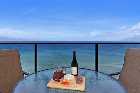 Enjoy meals on your private balcony overlooking the turquoise waters