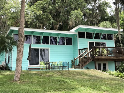 Rear view of house patio and upper deck