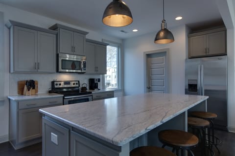 huge marble island with seating.  Coffee maker.  I supply; coffee, milk, sugar