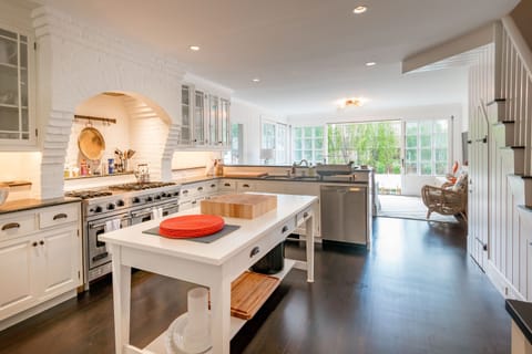 Kitchen looking out through family room to pool & terrace