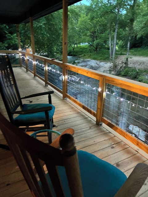 Upstairs porch overlooking the river. White lights sparkle!