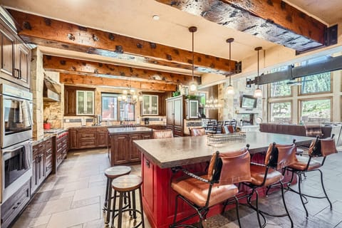 Open-concept kitchen with high-end appliances, perfect for preparing meals and enjoying drinks with friends and family.