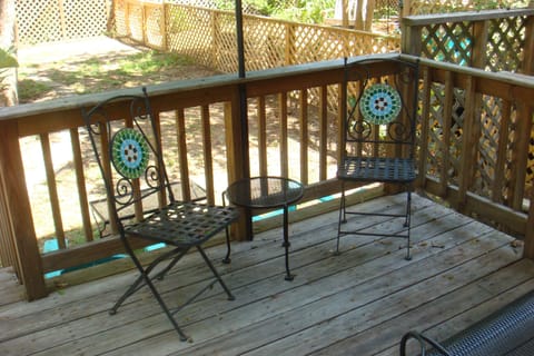 Seating area on deck leading to back yard and parking