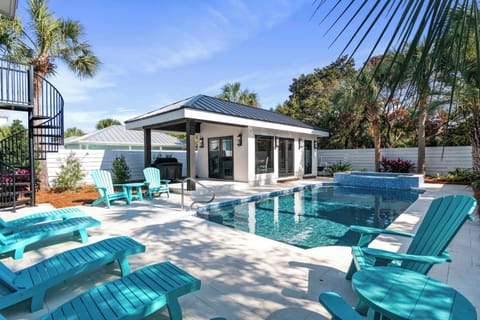 Resort-style patio w/ plush seating, pool & sunny lounging spots.