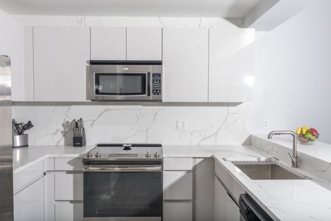 Well stocked new kitchen with stainless appliances