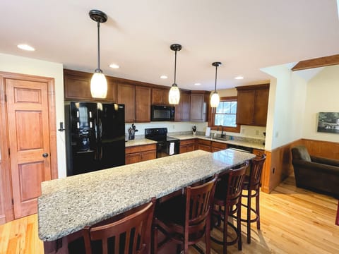 Fully stocked kitchen with bar seating for 4