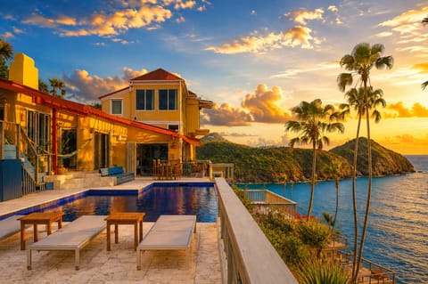 Watch the sky turn gold from a poolside lounger, villa glowing warm.