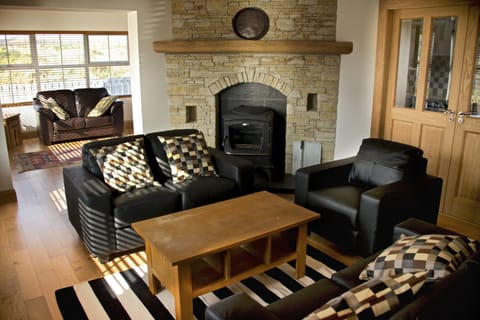 Lounge and sunroom with stone fireplace