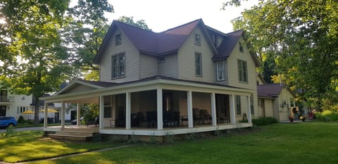 Forest House, wraparound porch with plenty of seating & tables