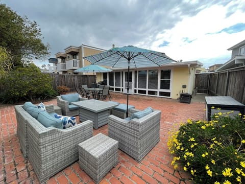 Spacious  patio with fire pit—perfect for relaxing after a day at the beach