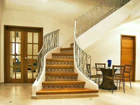 Living room staircase to 2nd floor, king suite, & private solarium