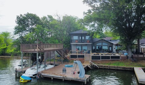 Stunning Lakefront Home with Private Dock, Slide, and Swimming Areas.