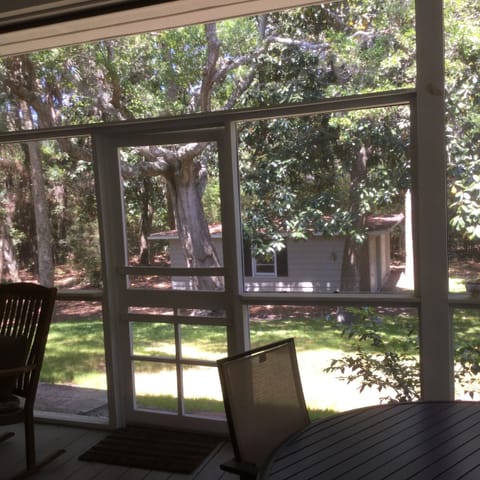 View of the private back yard and garage from the large rear porch.