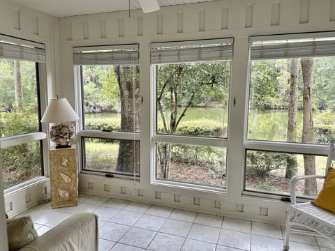 Bright sunroom with sleeper sofa couch. Enjoy lagoon views.